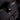 Close-up of a black bag with a visible brand logo on a dark background