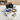 A complete R22 refrigerant recovery and filling kit laid out on a white table, including a black diaphragm pump, blue gauges, yellow and red hoses, copper braiding tools, a oil bottle, and a manifold gauge set. The background shows a softly blurred wooden shelf.